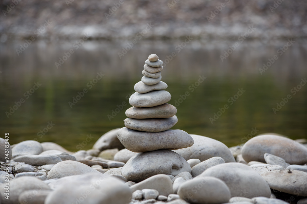 Amazing round stone near a flowing river, Stones are perfectly balanced on one another and forming, These are river stones, or also buddha stones