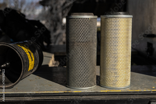 Obraz na płótnie Comparison of old and new air filter of a truck or van. Metal mesh filter with paper insert, side by side dirty and clean version. w salonie