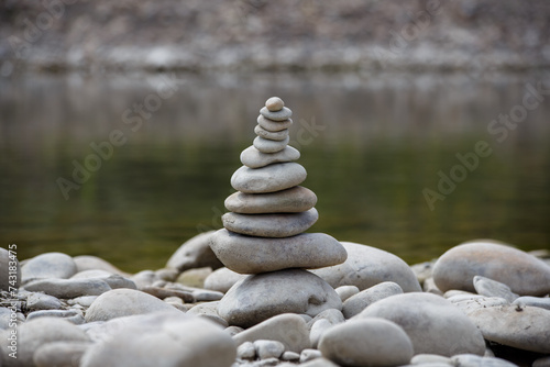 Obraz na płótnie Amazing round stone near a flowing river, Stones are perfectly balanced on one another and forming, These are river stones, or also buddha stones w salonie
