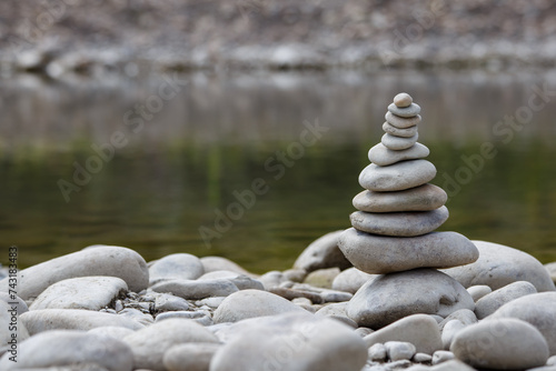 Obraz na płótnie Amazing round stone near a flowing river, Stones are perfectly balanced on one another and forming, These are river stones, or also buddha stones w salonie