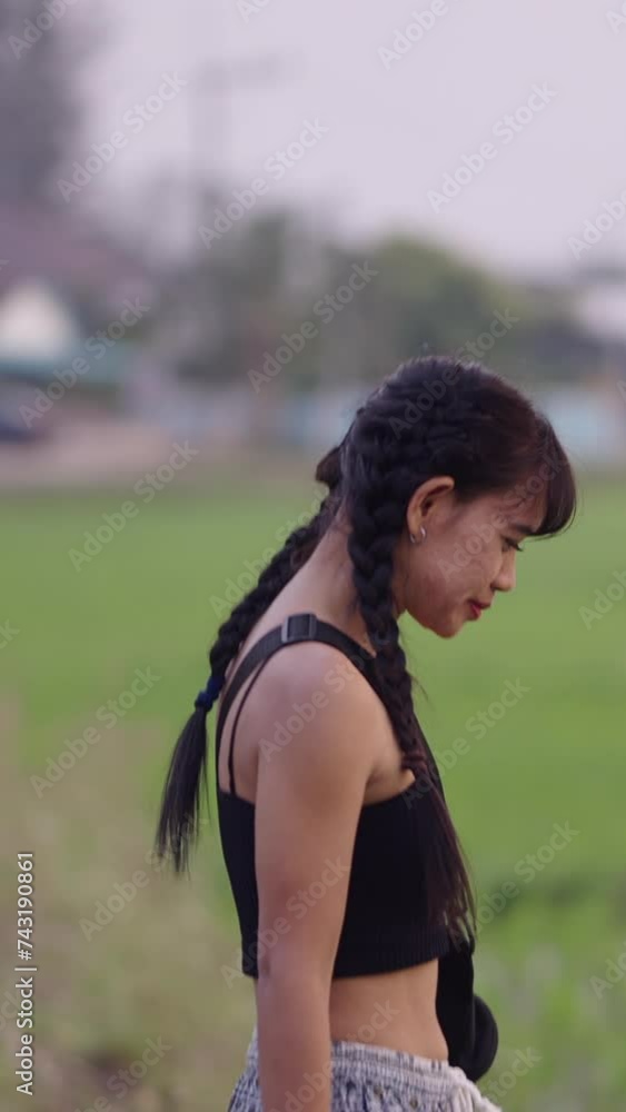 Thai girl invites the camera to walk through a rice field Thai girl invites the camera to walk through a rice field