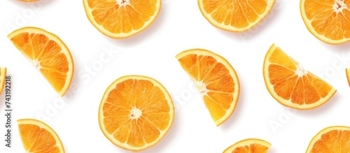 A collection of orange slices cut in half  revealing the juicy segments inside. The vibrant orange color contrasts with the white background  creating a visually appealing pattern.