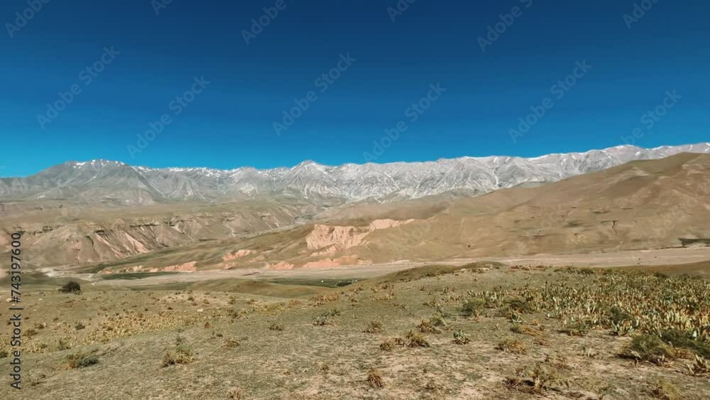 The mountain system of the Western Tien Shan in Uzbekistan. Panorama of the Western Tien Shan on the Angren plateau, Tashkent region. Promising orange mountains in the Western Tien Shan. 4K The mountain system of the Western Tien Shan in Uzbekistan. Panorama of the Western Tien Shan on the Angren plateau, Tashkent region. Promising orange mountains in the Western Tien Shan. 4K