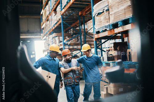 Diverse young men talking on break in warehouse photo