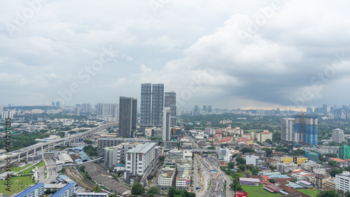 A bird's-eye view of a large cityscape lined with tall buildings. And there is heavy traffic. The area was covered with dust and fog. © Darunee