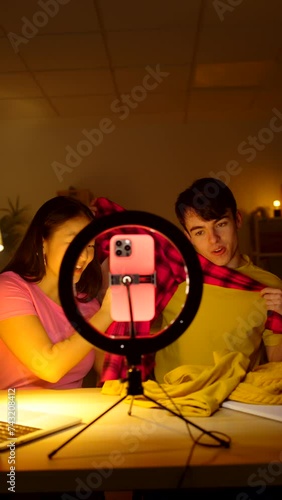 Two friends live streaming on phone. Teenagers recording tutorial for social media.
