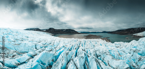 drone shot of an iceberg in Svalbard, a large piece of iceberg on the water in the middle of wild and frozen nature, usable for magazines and magazines, travel to arctic countries, Svalbard photo