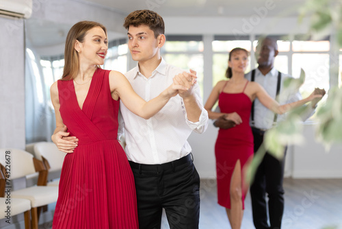 During rehearsal of reporting concert, young man and woman participants of dance workshop perform tango. Group training and rehearsal, preparation for competitions