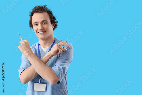 Young doctor with syringes ...