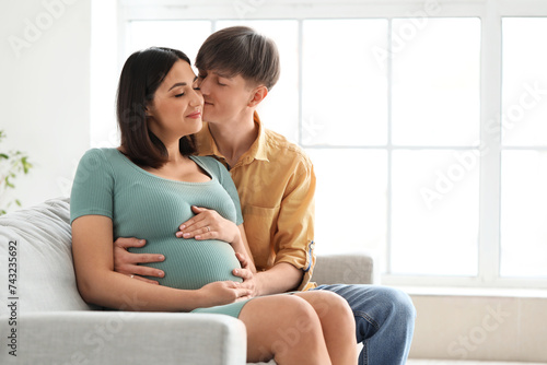 Young pregnant couple huggi...