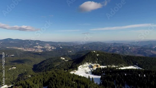 Bulgarian ski resort town, located close to Smolyan, heart of Rhodopi Mountain. Panning up Birds Eye View Mountainous area. GoPro gimbal stabilized 
 photo