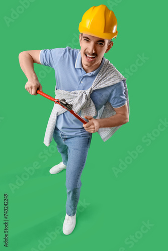 Male worker with wrench on ...