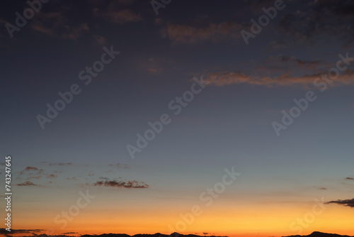 Beautiful sunset sky and clouds on the mountain range silhouette
