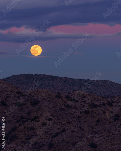 Full Moon Rising Over Desert Mountains