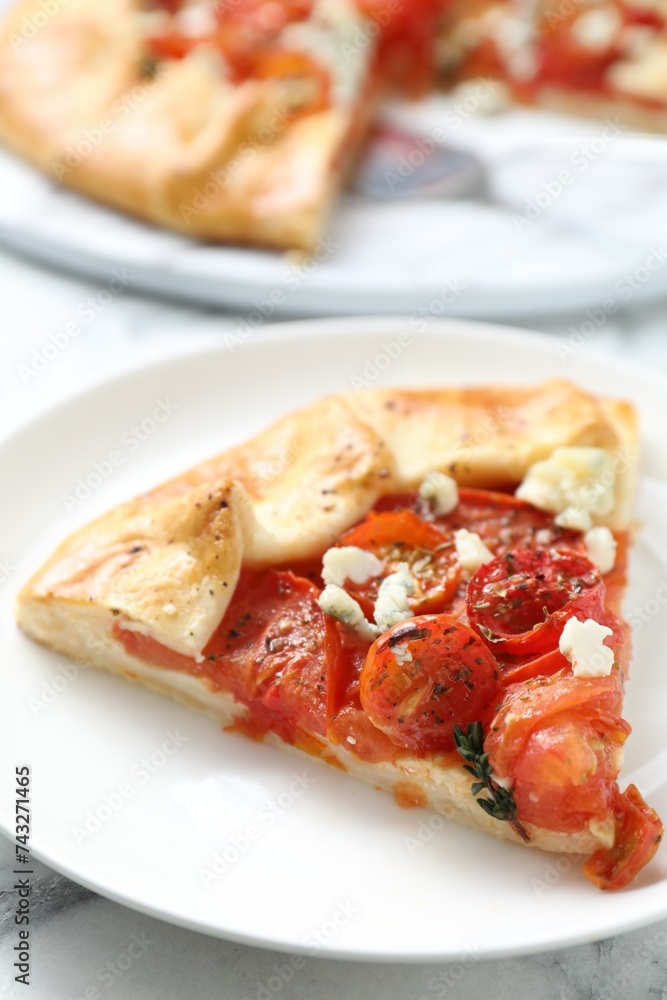 Tasty galette with tomato and cheese (Caprese galette) on white marble table, closeup Tasty galette with tomato and cheese (Caprese galette) on white marble table, closeup