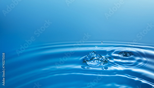 Close up of water with waves and ripples and copy space on blue background. Water, shape, liquid and colour concept.