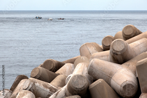 View of the sea with the tetrapods at the harbor on a cloudy day