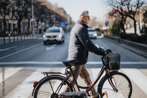 Mature adult male in casual attire cycling down a city road, promoting sustainable transportation and an active lifestyle.