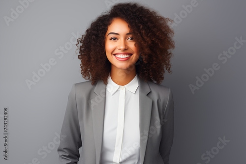 business black woman adjusting her clothes on a grey background