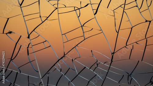 Sunset gradient through cracked glass