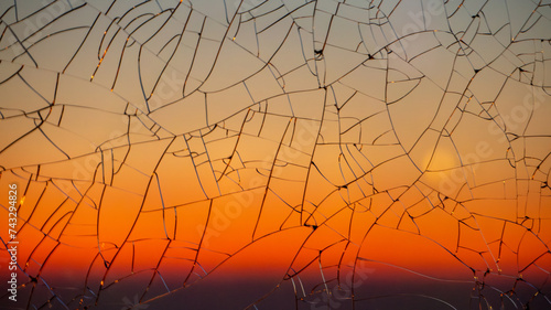 Sunset gradient through cracked glass