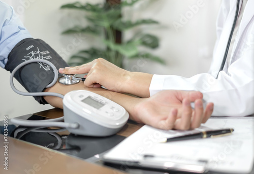 The female doctor measured blood pressure, the patient examined the heartbeat and sat down to talk about health care closely. health care concept