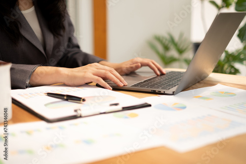businesswoman calculate financial graphs showing results about their investments and plan successful business growth process