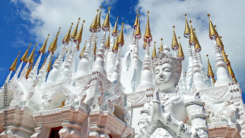 Beautiful small white stupas (chedi) laced with golden spires at Wat Phong Sunan of Phrae, Thailand :The temple of the Tortoise  photo