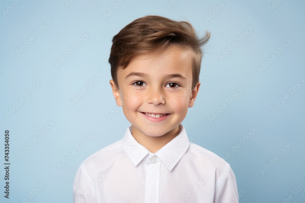 Portrait of a smiling little boy in a white shirt on a blue background Portrait of a smiling little boy in a white shirt on a blue background