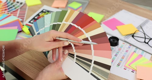 Female hands holding color palette in office photo