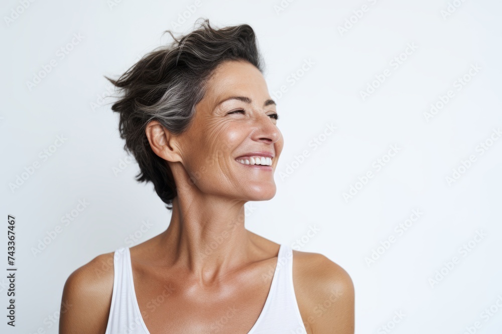 Closeup portrait of a happy mature woman smiling against white background. Closeup portrait of a happy mature woman smiling against white background.