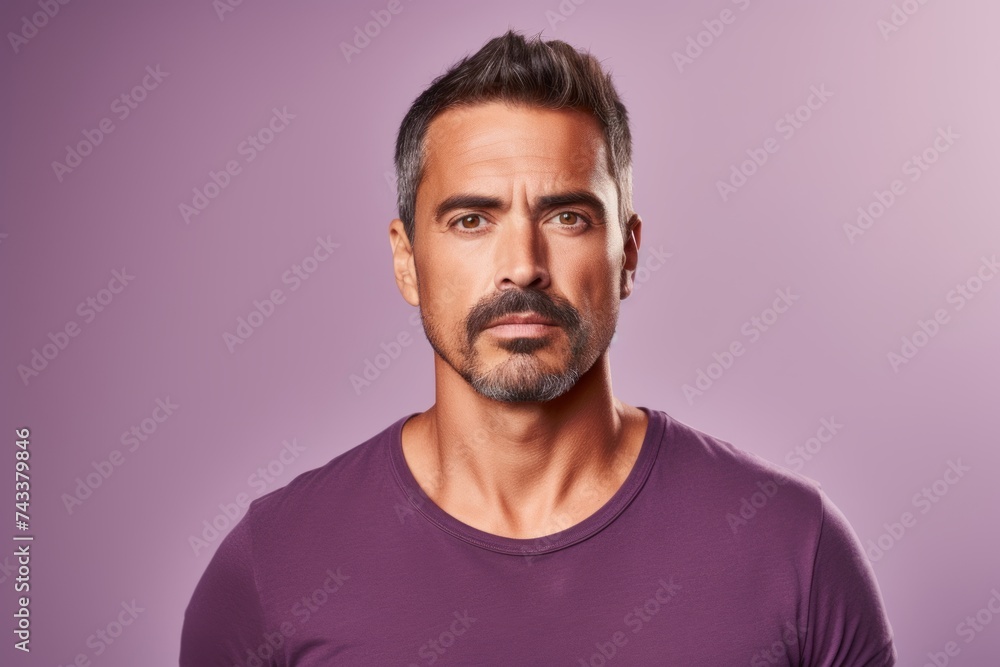 Portrait of a handsome mature man with beard and mustache on a purple background. Portrait of a handsome mature man with beard and mustache on a purple background.