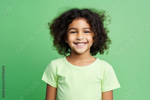 smiling african american little girl in green t-shirt