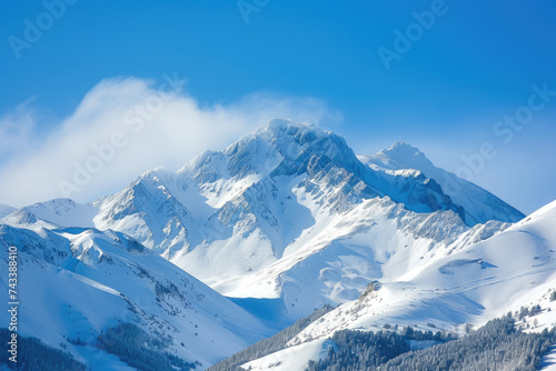 view of a snowy mountain peak with a blue sky © Formoney