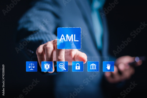 AML, Anti money laundering financial bank concept. businessman use smartphone with AML icon on virtual interface for anti money laundering regulations. photo