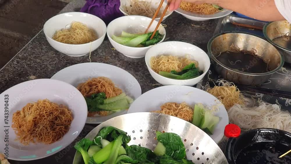 Chef hand making wonton noodles soup at restaurant 's kitchen, mi hoanh thanh bowl Chef hand making wonton noodles soup at restaurant 's kitchen, mi hoanh thanh bowl