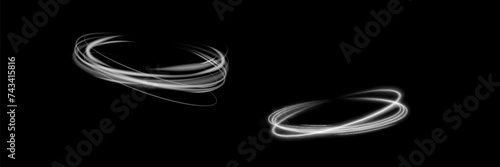 Magical light effect. Rotating luminous ellipses. Dynamic golden rings on black background