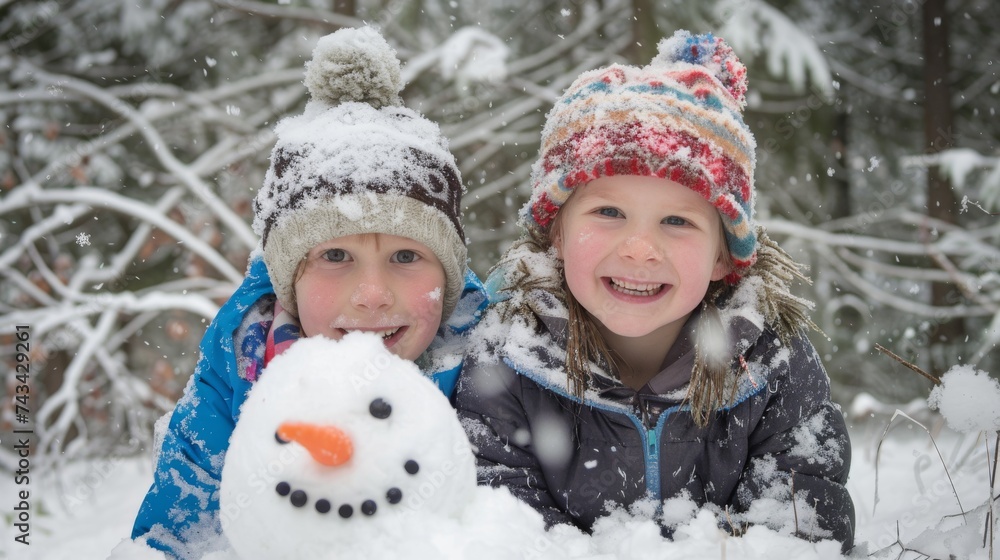 Two joyful children in winter hats smiling widely as they play with a snowman in a snowy forest, embodying the spirit of winter joy.
