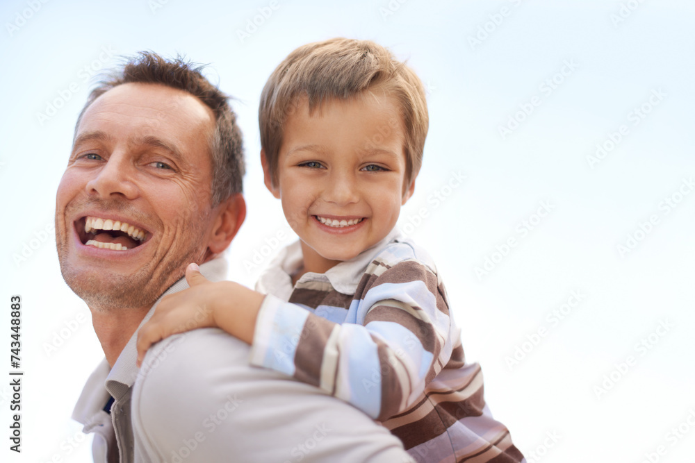 Father, son and piggyback in portrait on vacation, bonding and playful by blue sky on summer holiday. Daddy, child and carrying game for fun, nature and support on adventure and laughing on weekend Father, son and piggyback in portrait on vacation, bonding and playful by blue sky on summer holiday. Daddy, child and carrying game for fun, nature and support on adventure and laughing on weekend