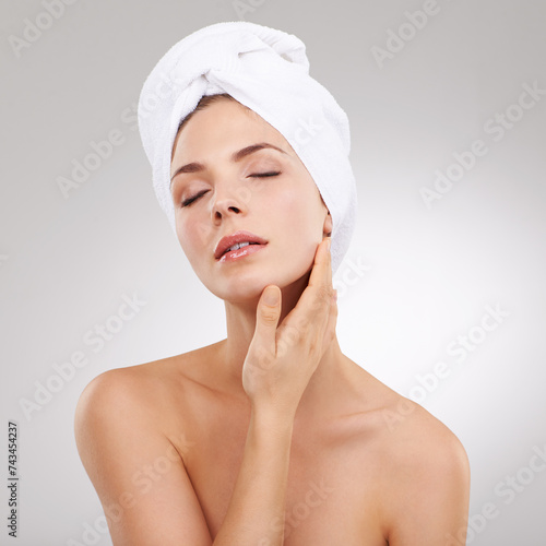 Skincare, cosmetics and face of woman with towel, natural glow and getting ready in studio. Dermatology, healthy skin and girl on white background with luxury facial, morning routine and beauty.