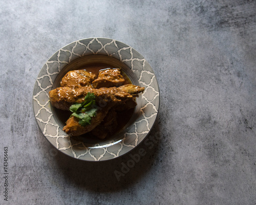 Kerala style chicken curry served in a bowl. View from top. photo