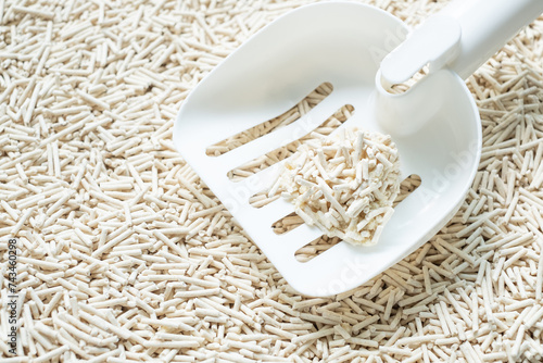 White scoop with a small wet clumping tofu cat litter