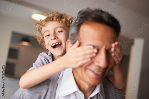 Portrait, grandfather and boy with piggyback and smile for multiracial, family and bonding together. Happy, mature man and male grandchild with hug for laugh, cheerful and fun babysitting at home photo