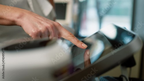 A close-up of a cosmetologist pressing the buttons in the device for beauty procedures. High quality 4k footage photo