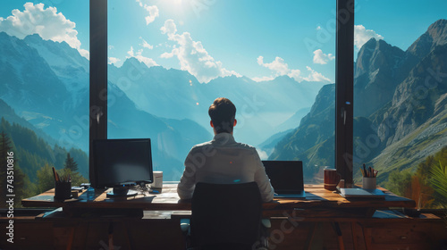 A Man in office clothes sitting and working in mountain office