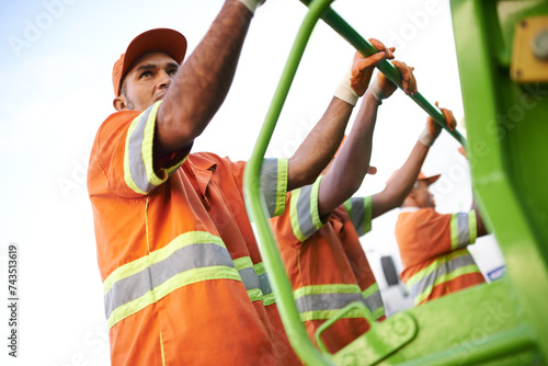 Industry, waste management and garbage truck with men in uniform cleaning outdoor on city street. Job, service and male people working with rubbish for sanitation, maintenance or collection of dirt. photo