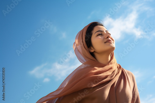 Serene Woman with Headscarf Looking Upwards  Peacefulness and Spirituality Concept