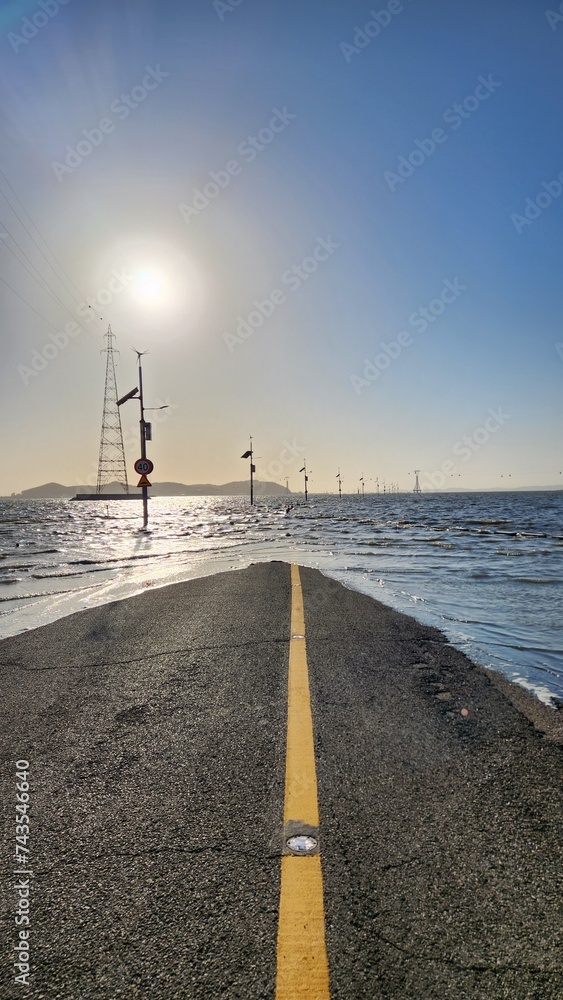 the view of the road submerged in the sea at high tide