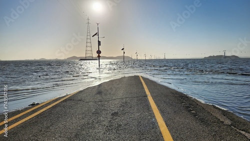 Canvas Print the view of the road submerged in the sea at high tide
