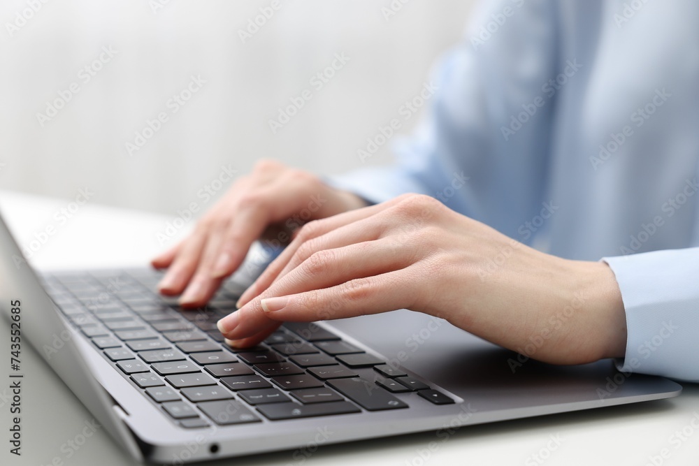 E-learning. Woman using laptop at white table indoors, closeup E-learning. Woman using laptop at white table indoors, closeup